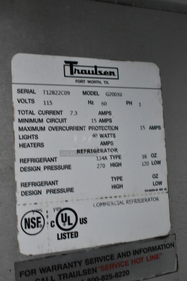 Traulsen G20010 stainless steel commercial 2-door cooler, 115V, with poly coated racks, on casters. Serial: T12822C09.