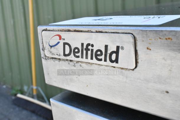 Delfield UCD4464N-12-DD prep table, stainless steel, logo visible, used condition, commercial kitchen equipment.