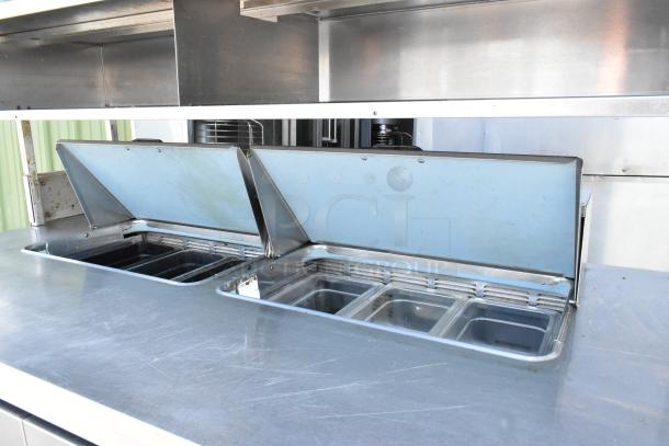 Delfield UCD4464N-12-DD stainless steel prep table with bain marie top, four drawers, overshelf, on casters.