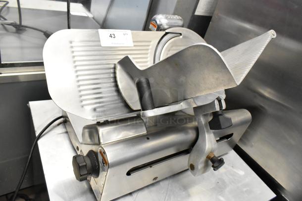Globe 400 stainless steel commercial meat slicer with blade sharpener, countertop model. 115 volts, 1 phase, excellent condition.