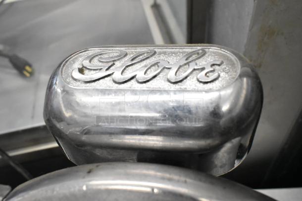 Globe 400 Stainless Steel Meat Slicer featuring a built-in blade sharpener; embossed "Globe" logo on top.