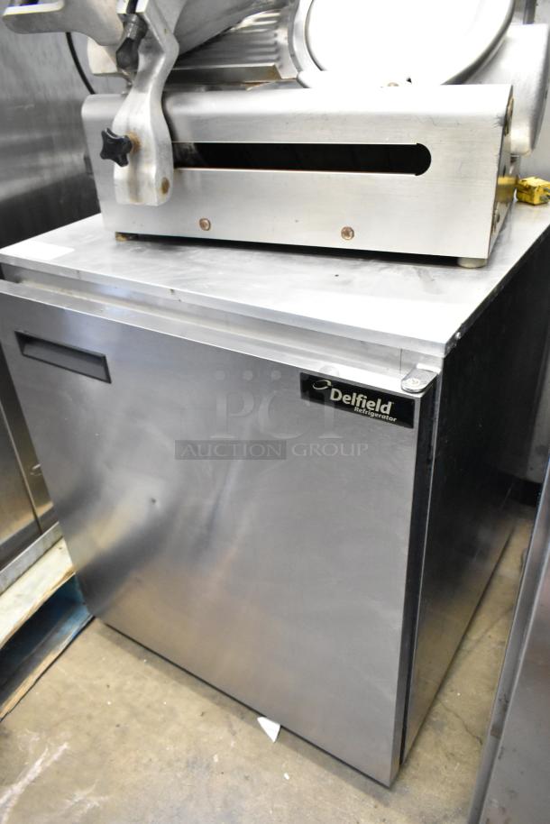 Delfield 406CA-DD1 stainless steel undercounter cooler. Single door, 115 volts, commercial use. Visible logo and model.