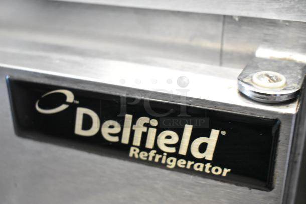 Delfield 406CA-DD1 stainless steel undercounter cooler. Single door, 115 volts, 1 phase. Brand label visible.