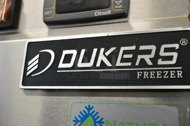 Dukers D28AF stainless steel commercial freezer, single door, poly-coated racks, on casters, model label displayed.