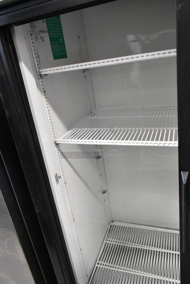 True GDM-41 metal commercial two-door reach-in cooler with poly-coated racks, on casters. 115V, 1 phase. Clean interior.