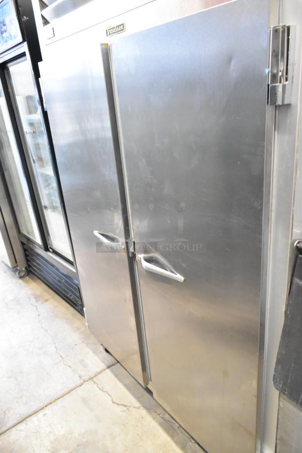 Traulsen G20010 stainless steel commercial 2-door reach-in cooler, features poly-coated racks and commercial casters, 115 volts, 1 phase, visible wear.