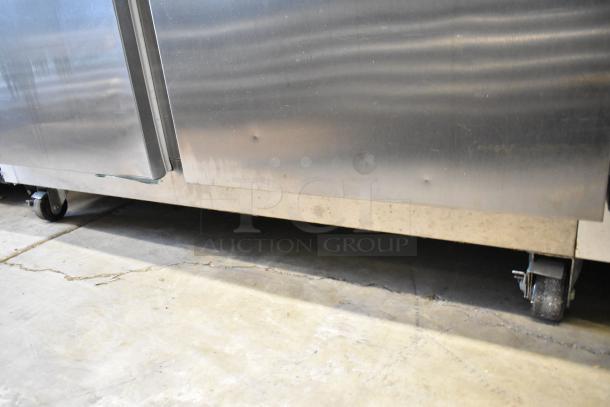Traulsen G20010 stainless steel 2-door reach-in cooler with dents, poly-coated racks, commercial casters. 115V, 1 phase.