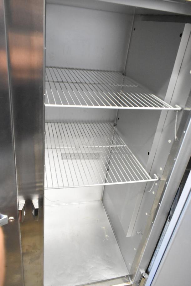 Traulsen G20010 stainless steel 2-door reach-in cooler, poly-coated racks, commercial casters, 115V, 1 phase.