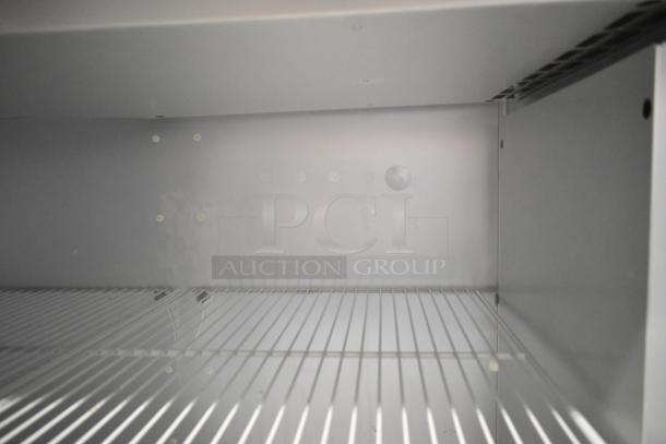 Traulsen G20010 stainless steel commercial cooler interior, showing poly coated racks. Clean, spacious design.