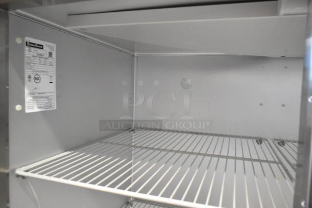 Traulsen G20010 stainless steel commercial cooler interior with poly-coated racks, showing label details. 115 volts, 1 phase.