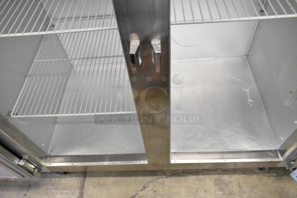 Traulsen G20010 stainless steel commercial 2-door cooler with poly-coated racks and commercial casters, 115 volts, 1 phase.