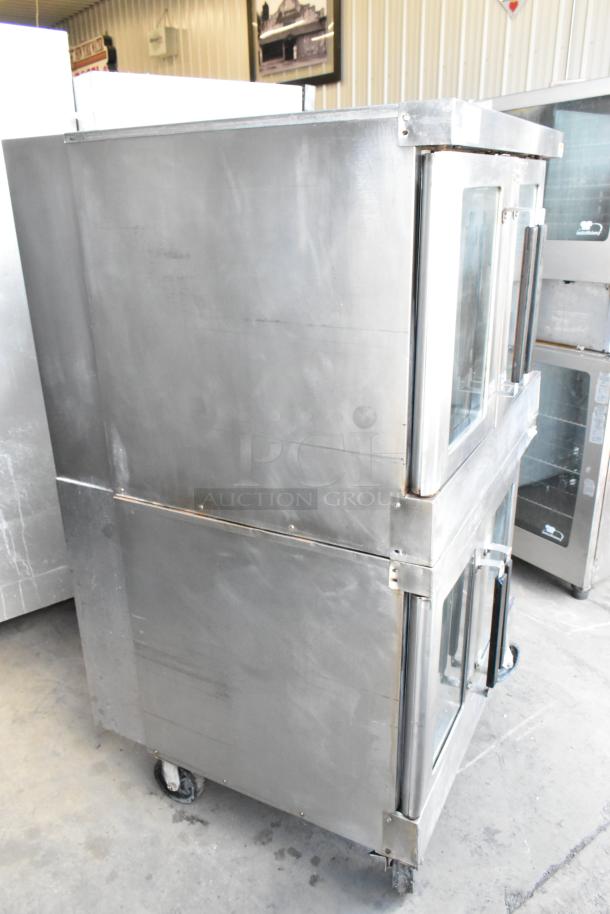 2 Vulcan VC4GD stainless steel commercial gas convection ovens with glass doors, metal racks, thermostatic controls, and casters.