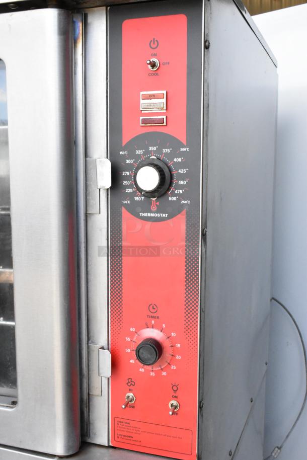 Vulcan VC4GD convection oven with stainless steel, view-through doors, metal racks, and thermostatic controls on casters.