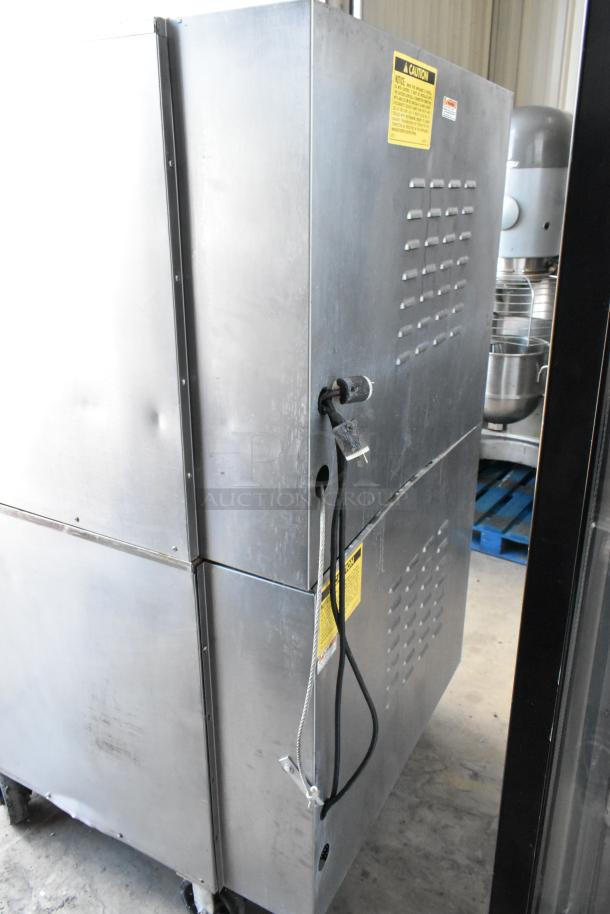 Vulcan VC4GD stainless steel commercial gas convection oven, view-through doors, metal racks, thermostatic controls, on casters.