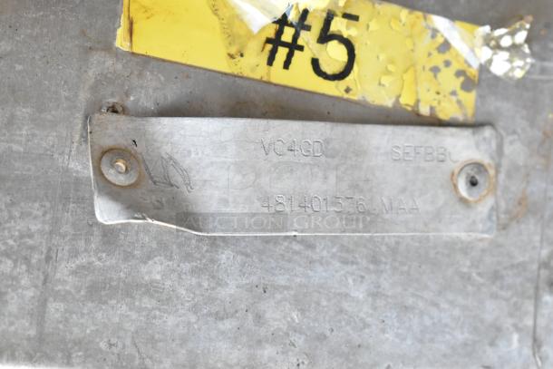 Metal plate showing Vulcan model VC4GD marking, attached with screws, next to a chipped yellow label with "#5".