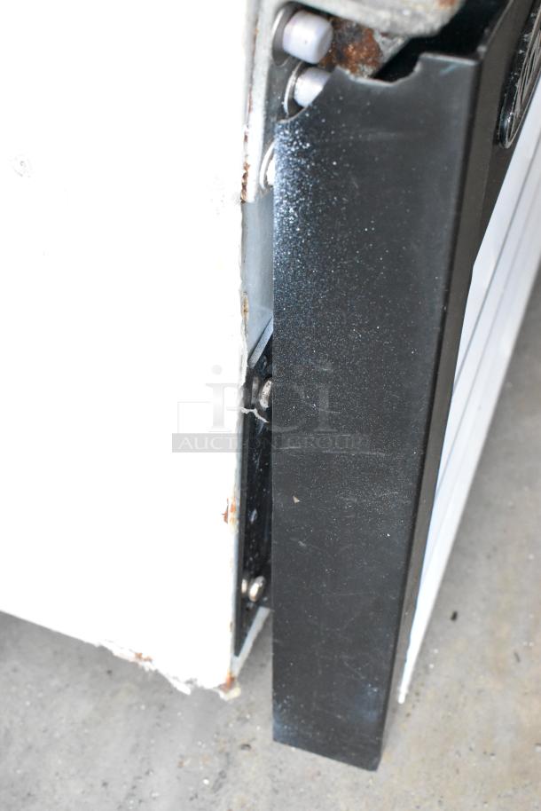 Close-up of Kool-It KGF-72 cooler hinge in used condition, showing signs of rust and wear.