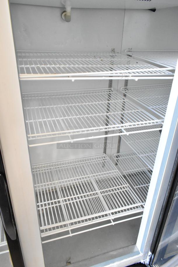 Kool-It KGF-72 3-door cooler with poly coated racks, metal construction, 115V, 1 phase, commercial use, clean interior.