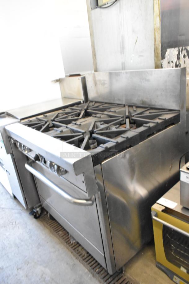 Southbend 4367A stainless steel commercial range with 4 burners, convection oven, and casters; natural gas, used condition.