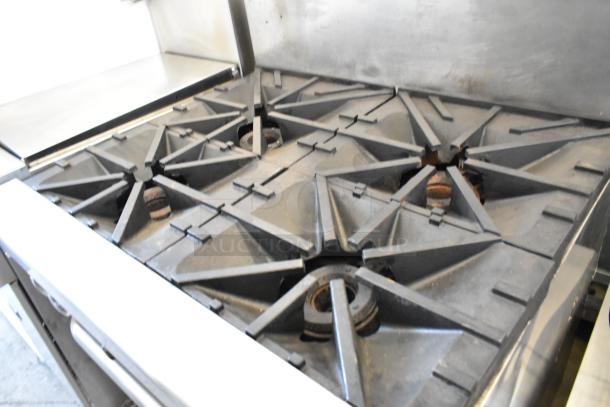 Southbend 4367A stainless steel 4-burner range with convection oven, natural gas, on commercial casters.