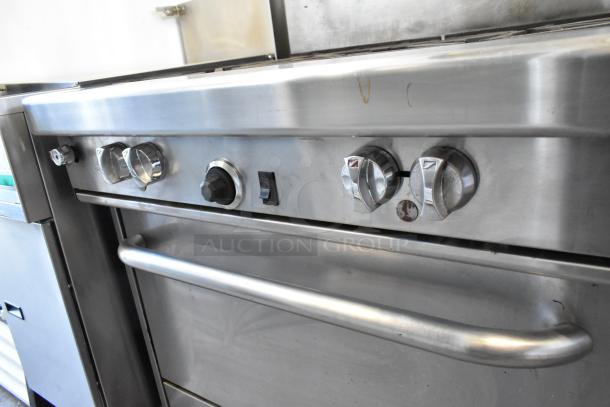 Southbend 4367A stainless steel commercial 4 burner gas range with convection oven, on casters, control knobs visible.