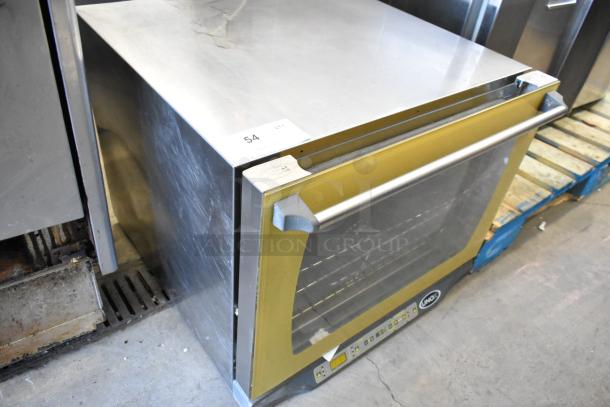 Cadco Unox stainless steel commercial countertop convection oven, electric-powered, 208/240V, visible wear, model label intact.