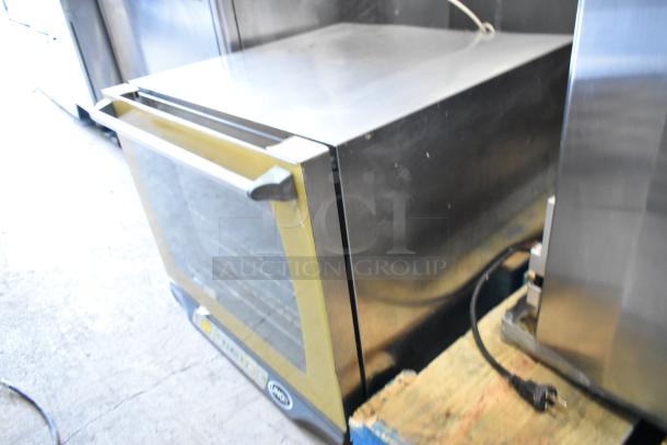 Cadco Unox stainless steel commercial convection oven, countertop model, 208/240V, electric, visible power cord, good condition.