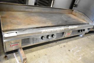 Lang stainless steel commercial countertop flat top griddle with knobs. Some wear visible. Lang brand label present.