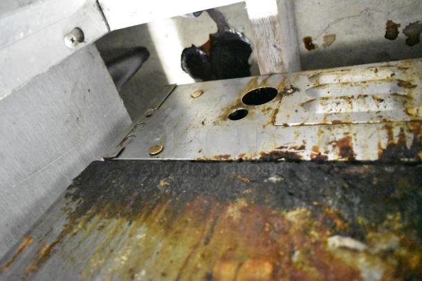 Lang Stainless Steel Commercial Flat Top Griddle, used condition, visible signs of wear and rust on the surface.