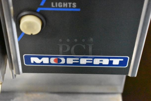 Moffat E89AMS Turbofan Convection Oven with thermostatic controls and metal racks, stainless steel finish on casters.