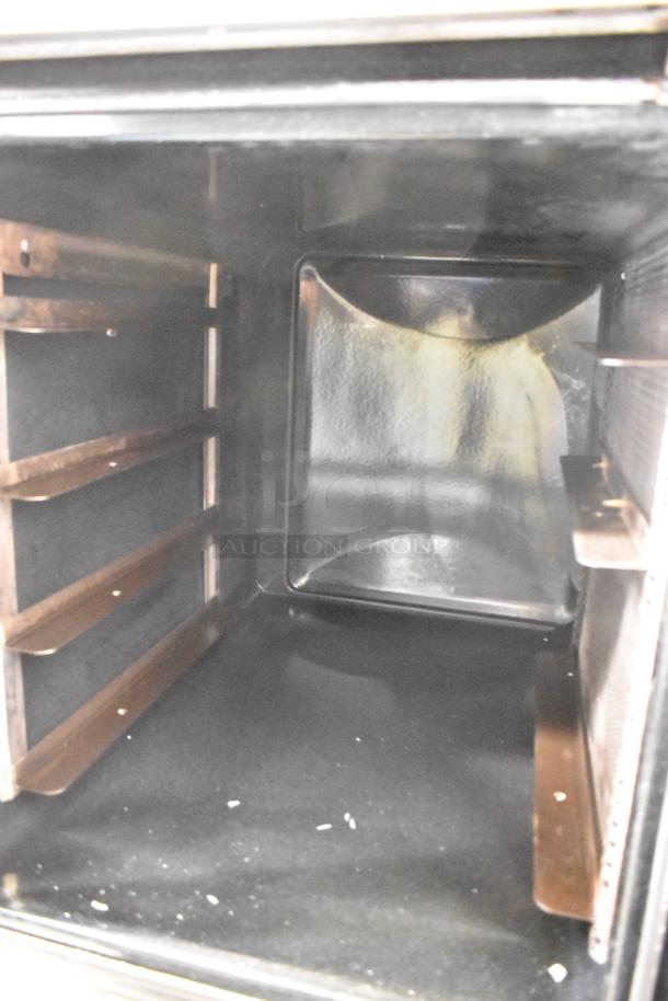 Interior of Moffat E89AMS Turbofan convection oven with metal racks, stainless steel finish, and spacious design.