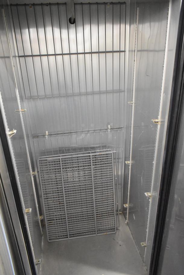 2017 True T-19F stainless steel commercial freezer, single door, interior view, shelving grid present, 115 volts, 1 phase.
