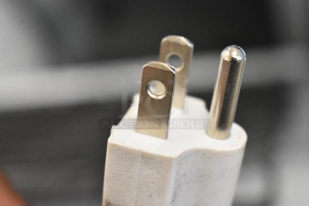 Close-up of a three-prong plug, likely for the 2019 Accucold ARG3PV Mini Cooler Merchandiser. 115 volts, 1 phase.