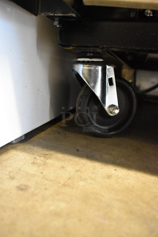 Wheel caster of a True T-35-HC stainless steel commercial cooler. Durable, facilitates movement.