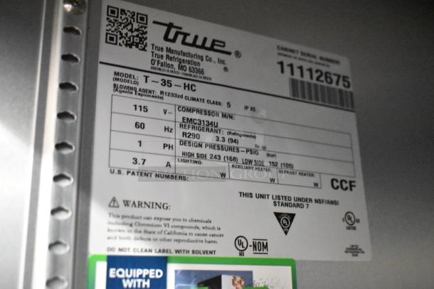 Label of True T-35-HC commercial cooler, showing model, voltage, phase, refrigerant type, and safety warnings.