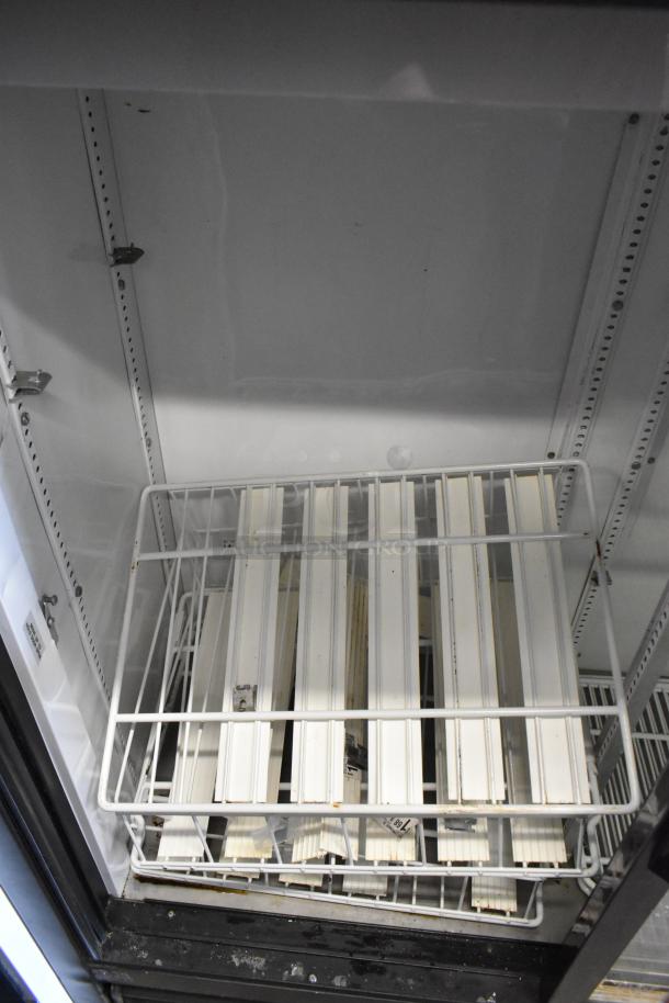 True GDM-41SL-54-LD commercial cooler interior with poly-coated racks, clean metal finish. 115 volts, 1 phase.