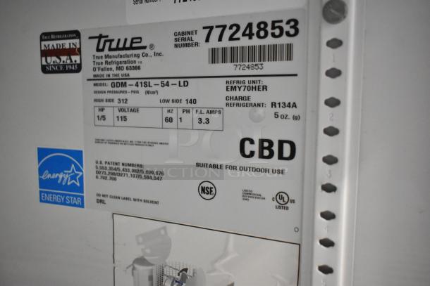 True GDM-41SL-54-LD cooler label showing model, voltage, serial number, and energy certifications; suitable for outdoor use.