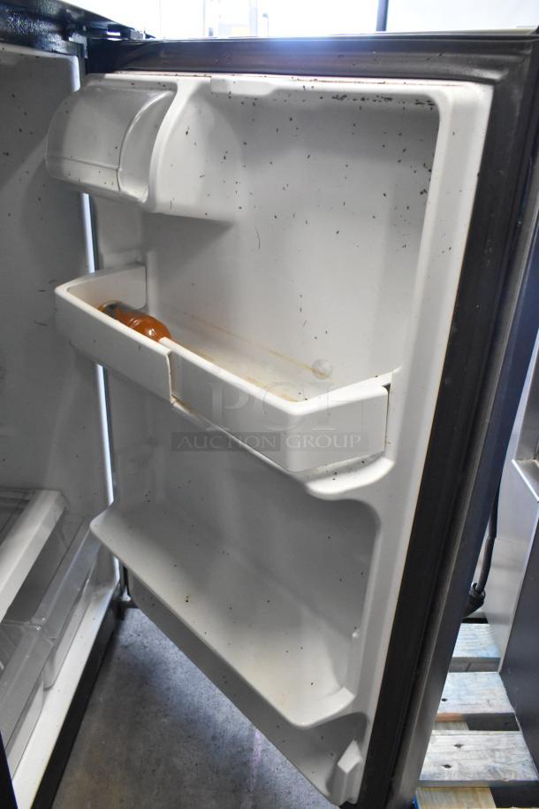 General Electric GE GTS17GSNDRSS refrigerator with visible wear, interior view. Stainless steel, 115V, 1 phase.