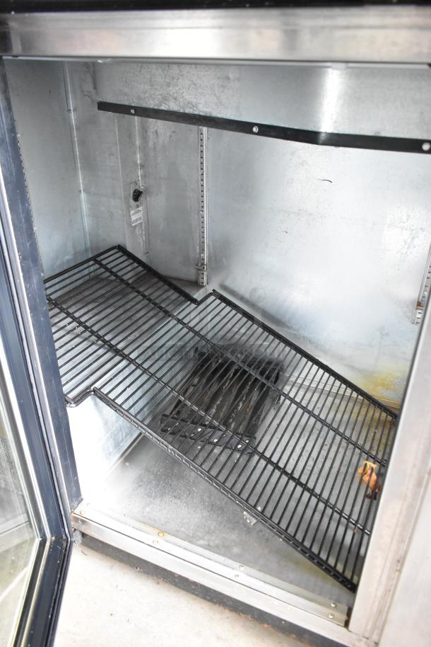 True TBB-4G-S-LD stainless steel 3-door back bar cooler interior, showing adjustable shelves and commercial-grade construction.