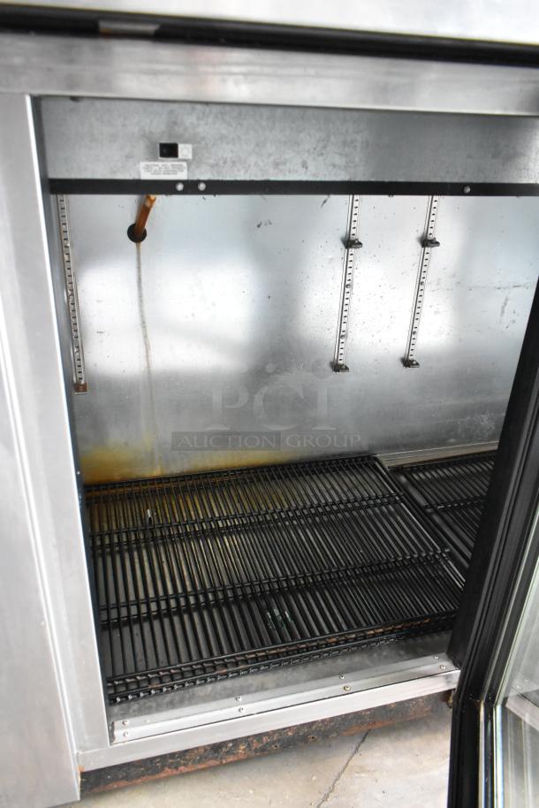 True TBB-4G-S-LD stainless steel 3-door back bar cooler with commercial casters, 115V, 1 Phase, interior shown.