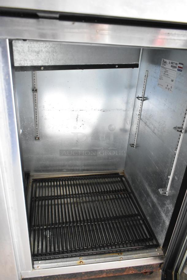 True TBB-4G-S-LD 3 Door Back Bar Cooler interior with commercial casters, stainless steel, 115V, 1 Phase, clean condition.