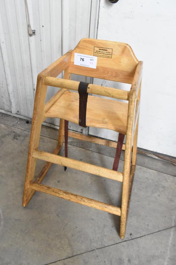 Wooden high chair with safety strap and visible wear. Label reads "SECURE child in restraint." Auction lot of 4.