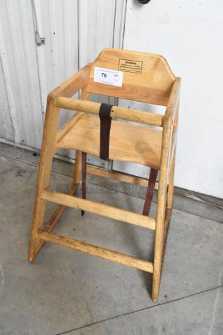 Wooden high chair with safety strap and visible wear. Label reads "SECURE child in restraint." Auction lot of 4.