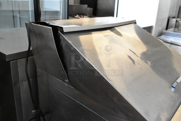 Atosa MGF8305GR stainless steel prep table with cosmetic dents, commercial casters, and electrical cord visible.