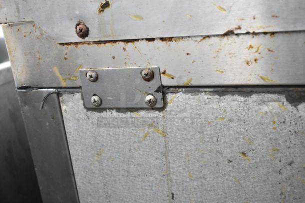 Atosa MGF8305GR stainless steel prep table with visible rust and wear, highlighting metal texture and joint detail.