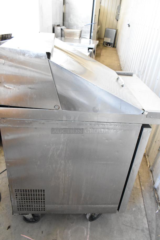Atosa MGF8305GR stainless steel sandwich prep table on casters, 115V, 1 phase, seen in a commercial setting.