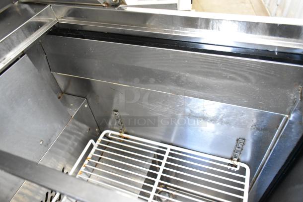 Atosa MGF8305GR stainless steel prep table interior, showing shelves and clean metal surfaces. 115V, 1-phase, on casters.