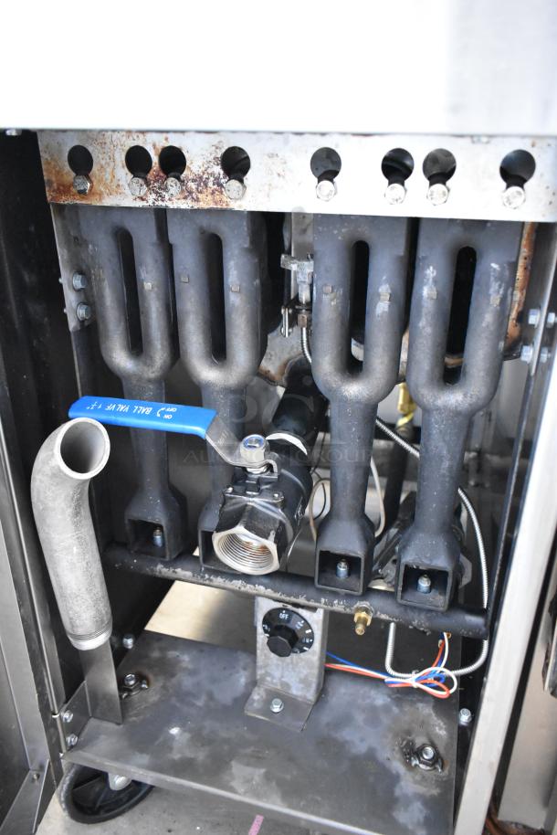 Cook Rite ATFS-50 stainless steel commercial gas fryer showing burners and control valves, 136,000 BTU, on casters.