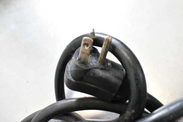 Close-up of a three-prong power plug for the Alto Shaam 750-S heated holding cabinet, showing cord condition.