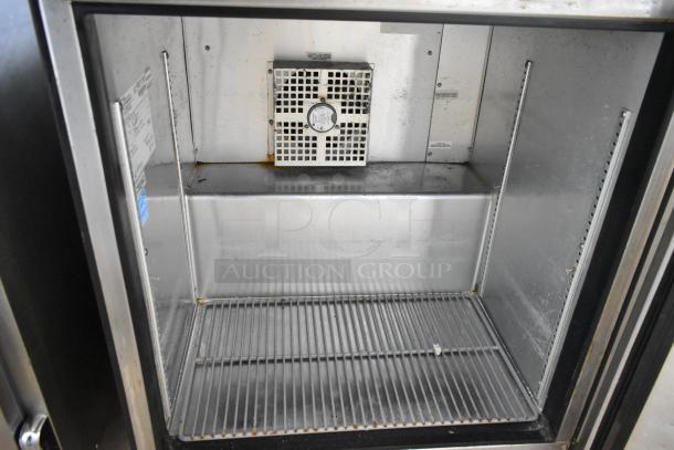 2016 True TUC-27-HC undercounter cooler, stainless steel, single door, commercial casters, clean interior, visible shelving.