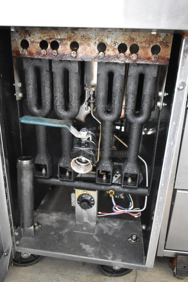 Cook Rite stainless steel commercial deep fat fryer, visible internal components, used condition, on commercial casters.